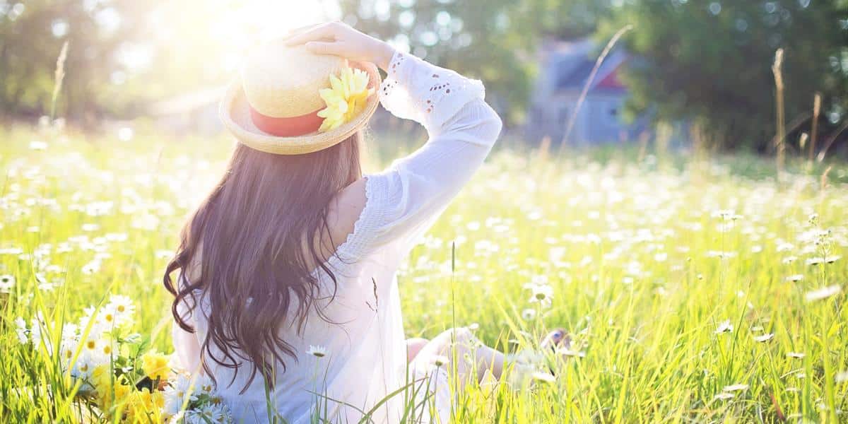 Woman in sunny green field