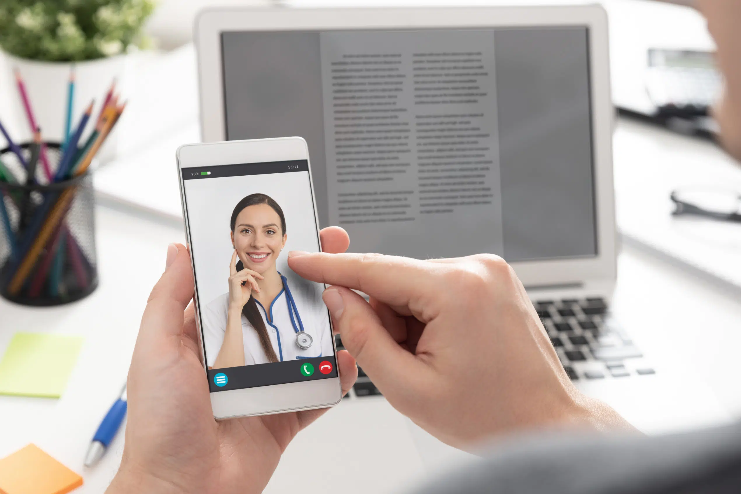 a patient holding a smart phone during a virtual care appointment